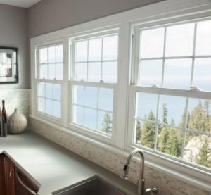 White vinyl windows in a kitchen overlooking a gorgeous view of trees and mountains